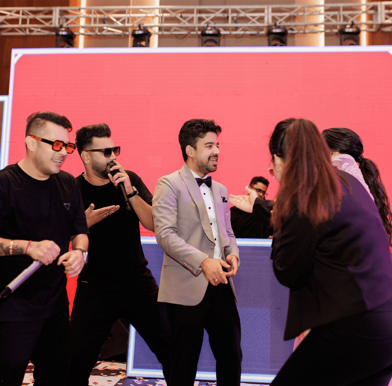 Artists and hosts performing on a wedding stage